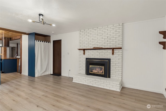 unfurnished living room featuring a textured ceiling, a fireplace, and light hardwood / wood-style flooring