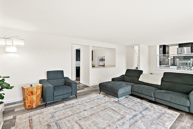 living room with baseboards and wood finished floors