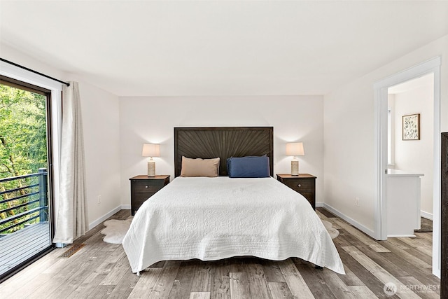 bedroom featuring baseboards, light wood-style floors, and access to exterior