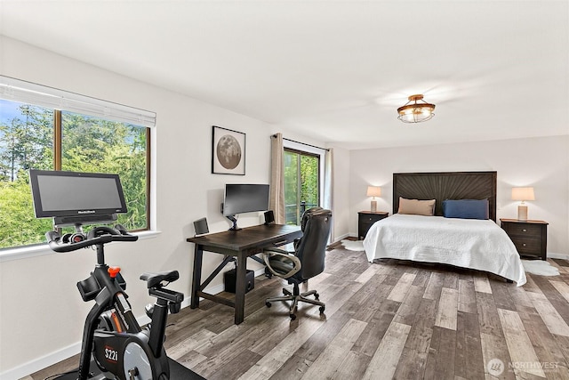 bedroom featuring wood finished floors and baseboards