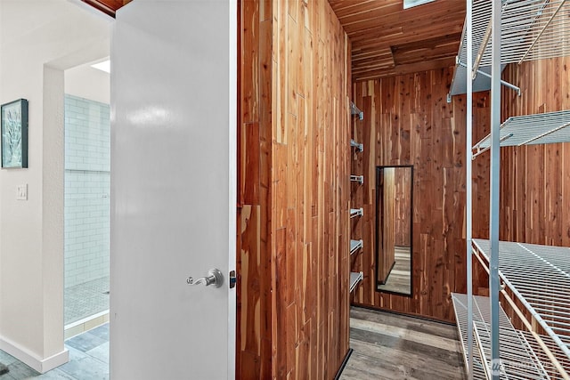 interior space featuring wood ceiling, wood finished floors, and wood walls