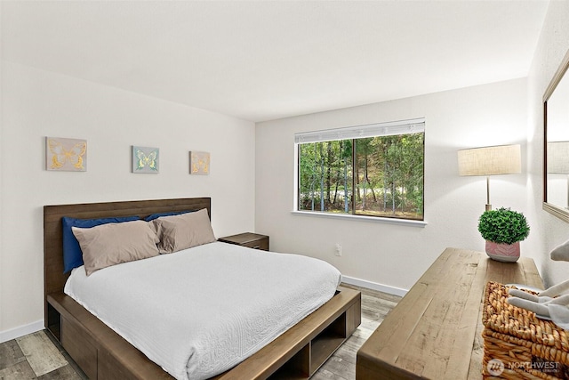 bedroom featuring wood finished floors and baseboards