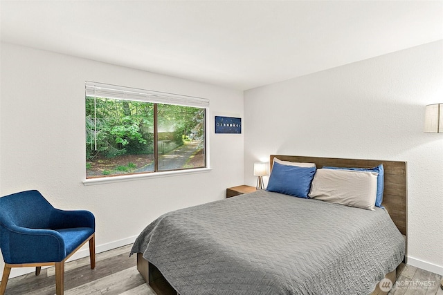 bedroom featuring baseboards and wood finished floors