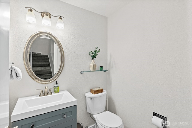 bathroom featuring toilet and vanity