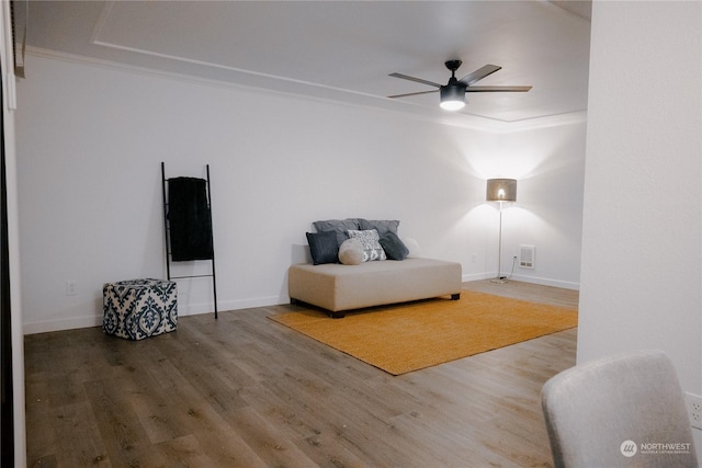 living area with ceiling fan and wood-type flooring