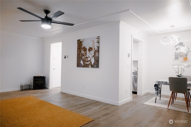 living room featuring crown molding, ceiling fan, and light wood-type flooring