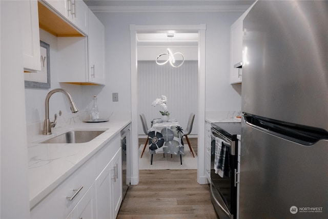 kitchen featuring sink, light hardwood / wood-style flooring, stainless steel appliances, light stone countertops, and white cabinets