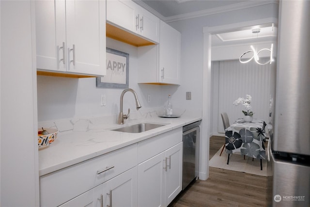 kitchen with sink, crown molding, dishwasher, and white cabinets