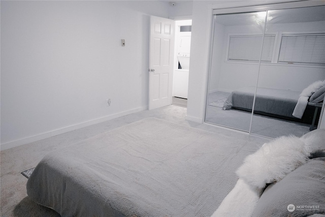 carpeted bedroom with a closet