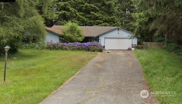 view of front of property with a garage and a front yard