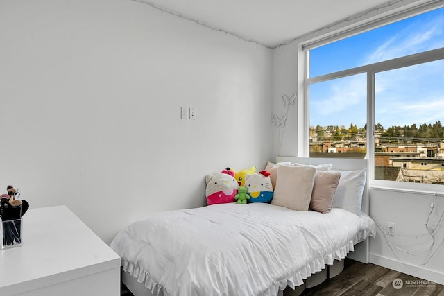 bedroom with dark wood-type flooring