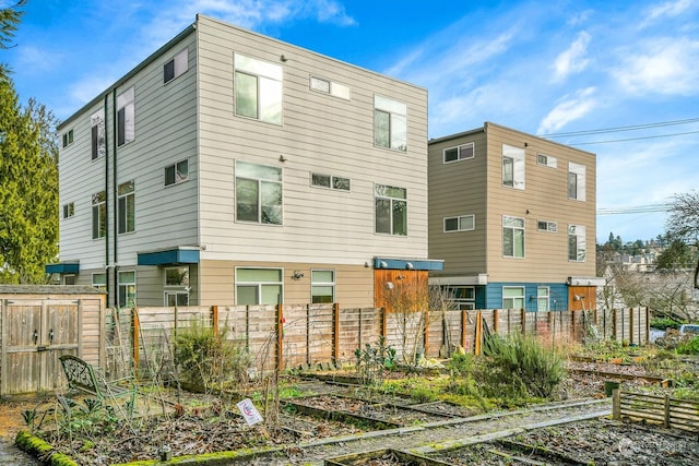 rear view of property featuring a storage unit