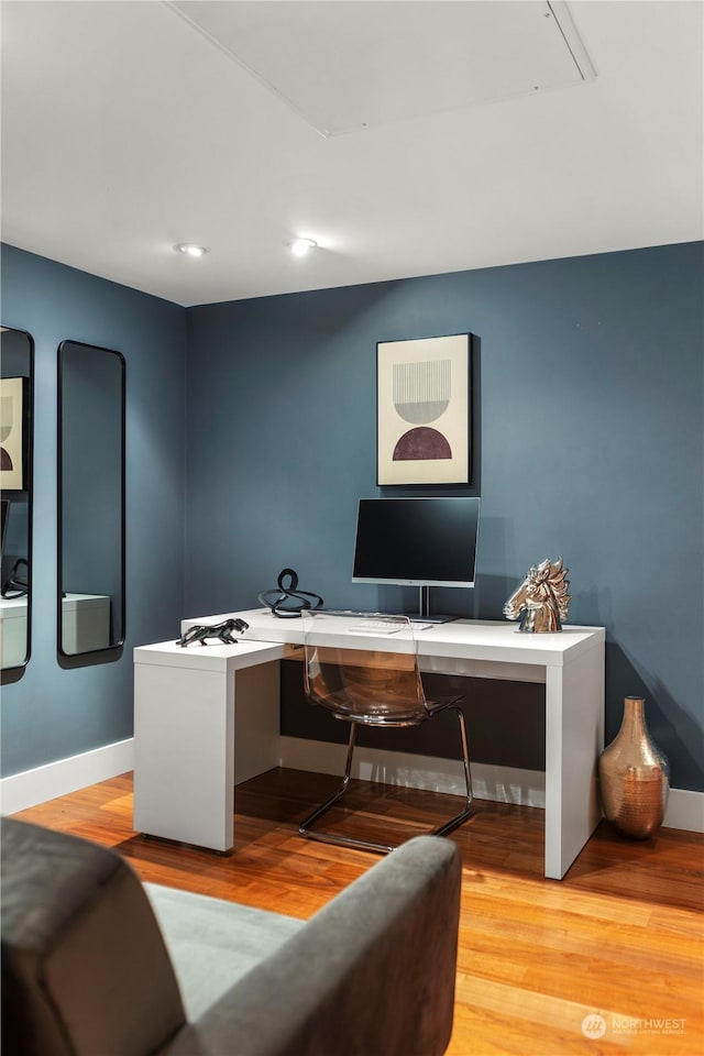 office featuring built in desk and light wood-type flooring