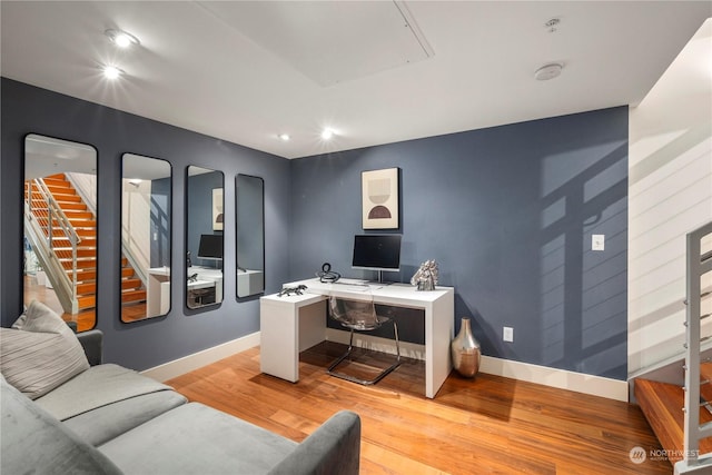 home office with light hardwood / wood-style floors