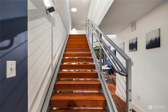 stairs featuring hardwood / wood-style floors