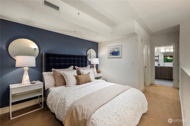 bedroom featuring carpet floors and ensuite bath