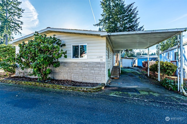 view of side of home with a carport