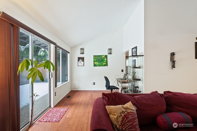 living room with lofted ceiling and light hardwood / wood-style floors