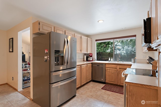 kitchen with light tile patterned flooring, stainless steel appliances, and light brown cabinets