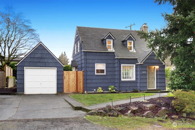 view of front of home with a garage and a front lawn