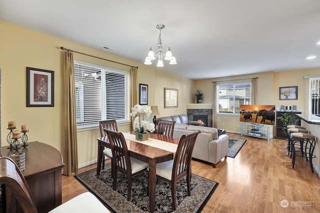 dining area featuring a notable chandelier and light hardwood / wood-style floors