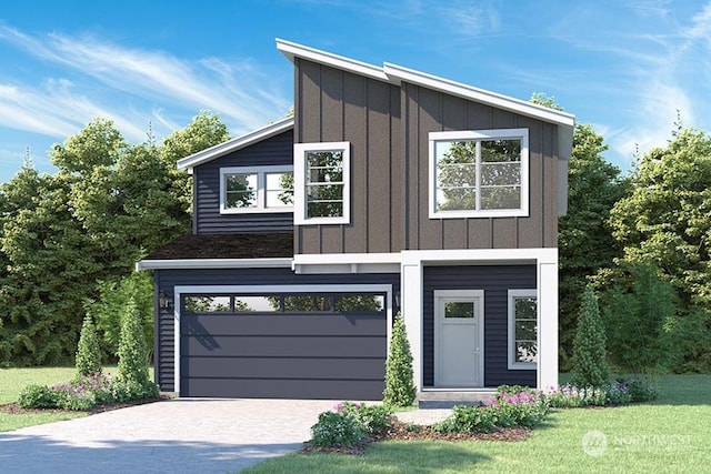 contemporary home featuring a garage and a front yard