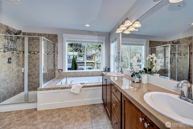 bathroom featuring a stall shower, plenty of natural light, and a sink