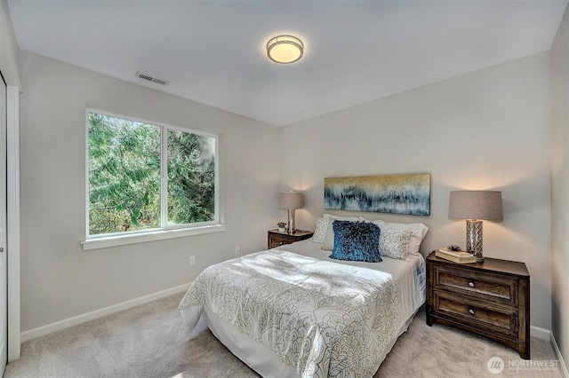 bedroom featuring light carpet, visible vents, and baseboards