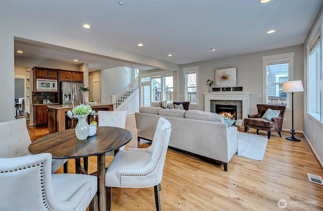 dining area featuring light wood-style floors, visible vents, a wealth of natural light, and recessed lighting