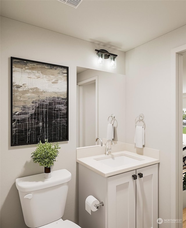 bathroom with vanity and toilet