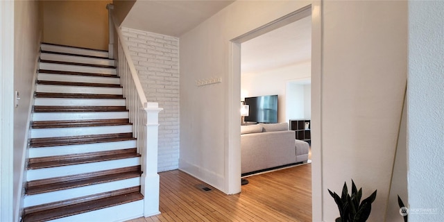 staircase with hardwood / wood-style floors