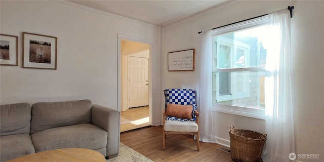 living room featuring visible vents, plenty of natural light, and wood finished floors