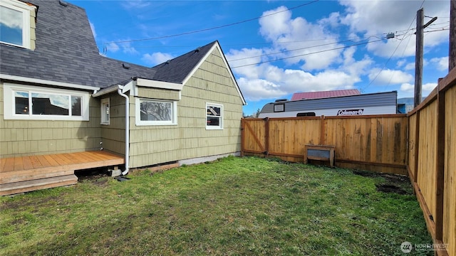 view of yard featuring a fenced backyard and a wooden deck