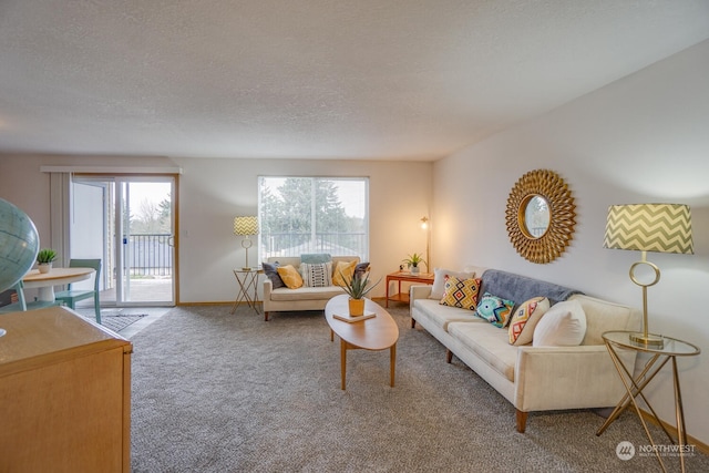 living room featuring a wealth of natural light, carpet floors, and a textured ceiling