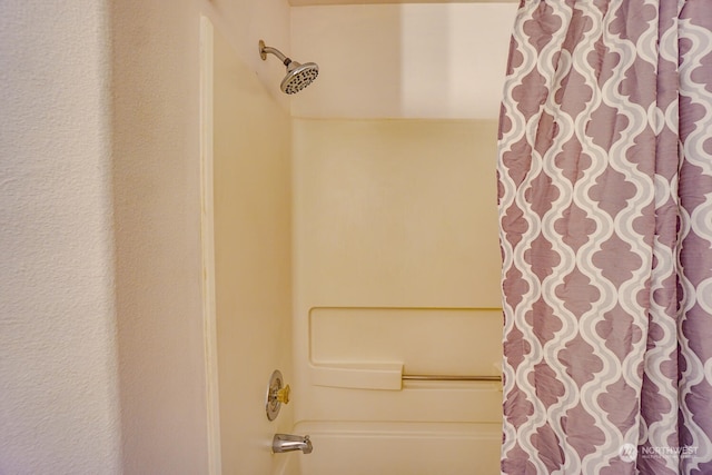 bathroom with shower / bath combo with shower curtain