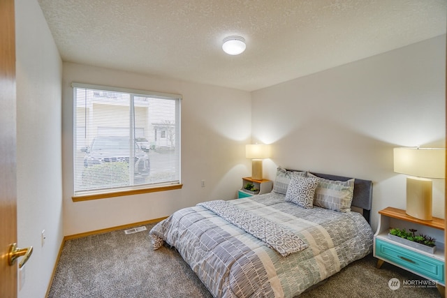 carpeted bedroom with a textured ceiling