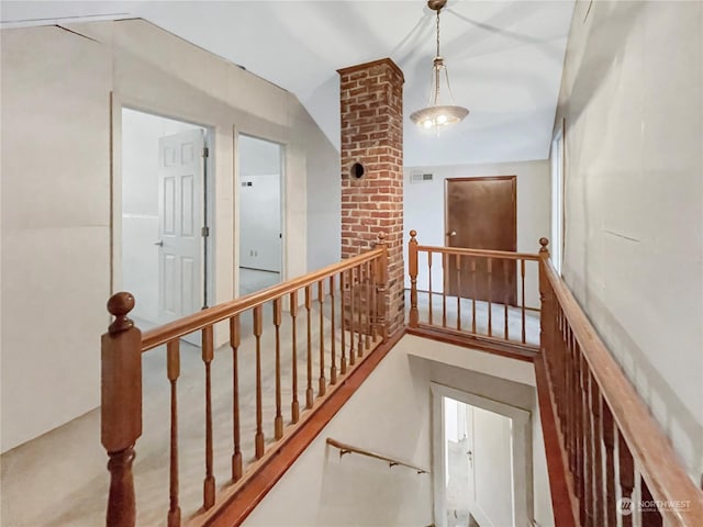 hallway with lofted ceiling