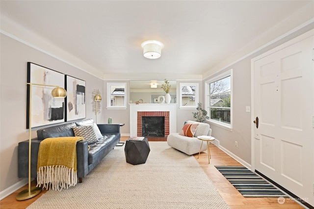 living room with wood-type flooring and a brick fireplace