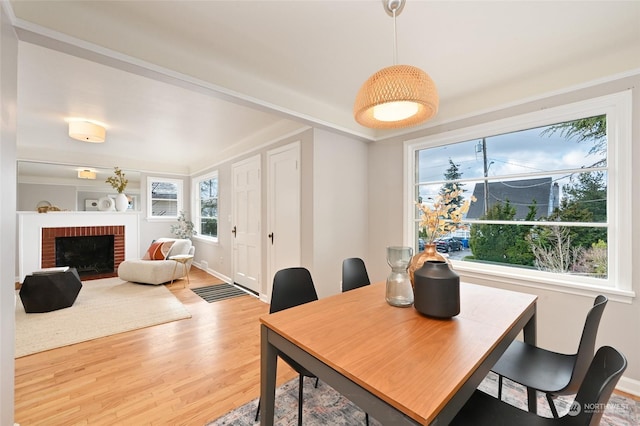 dining room with a fireplace and wood-type flooring