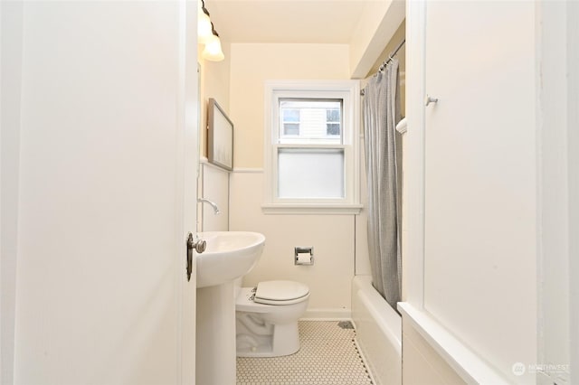 bathroom featuring shower / tub combo with curtain, tile patterned floors, and toilet