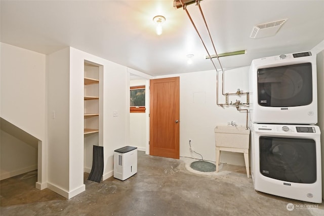 laundry area featuring stacked washer / dryer