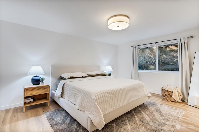 bedroom with hardwood / wood-style floors