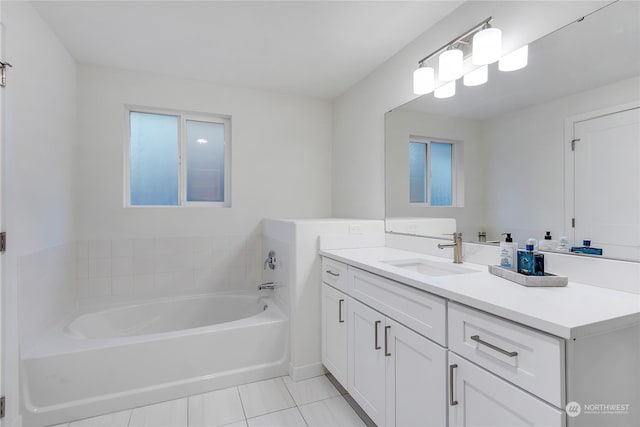 bathroom with vanity, a washtub, and tile patterned floors