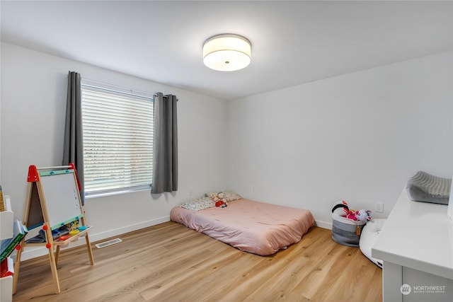 bedroom with light hardwood / wood-style flooring