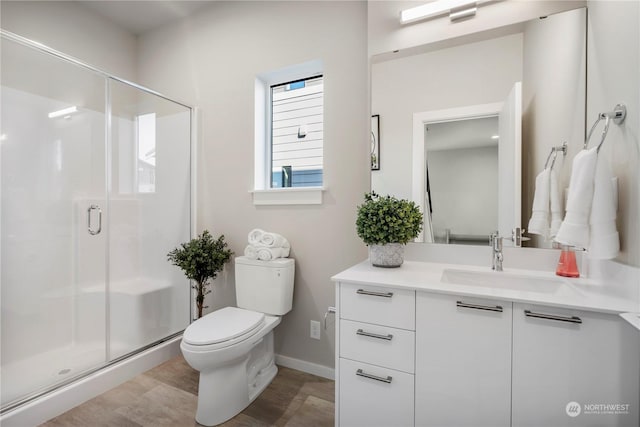 bathroom featuring walk in shower, vanity, and toilet