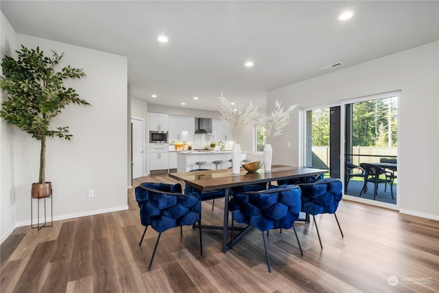 dining area with hardwood / wood-style flooring