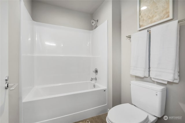 bathroom featuring hardwood / wood-style floors, shower / tub combination, and toilet