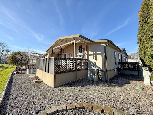 view of side of property with central AC unit