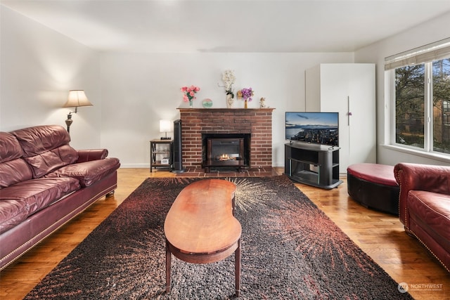 living room with wood-type flooring and a fireplace