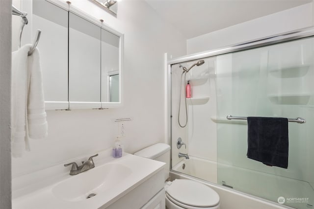 full bathroom featuring vanity, toilet, and combined bath / shower with glass door